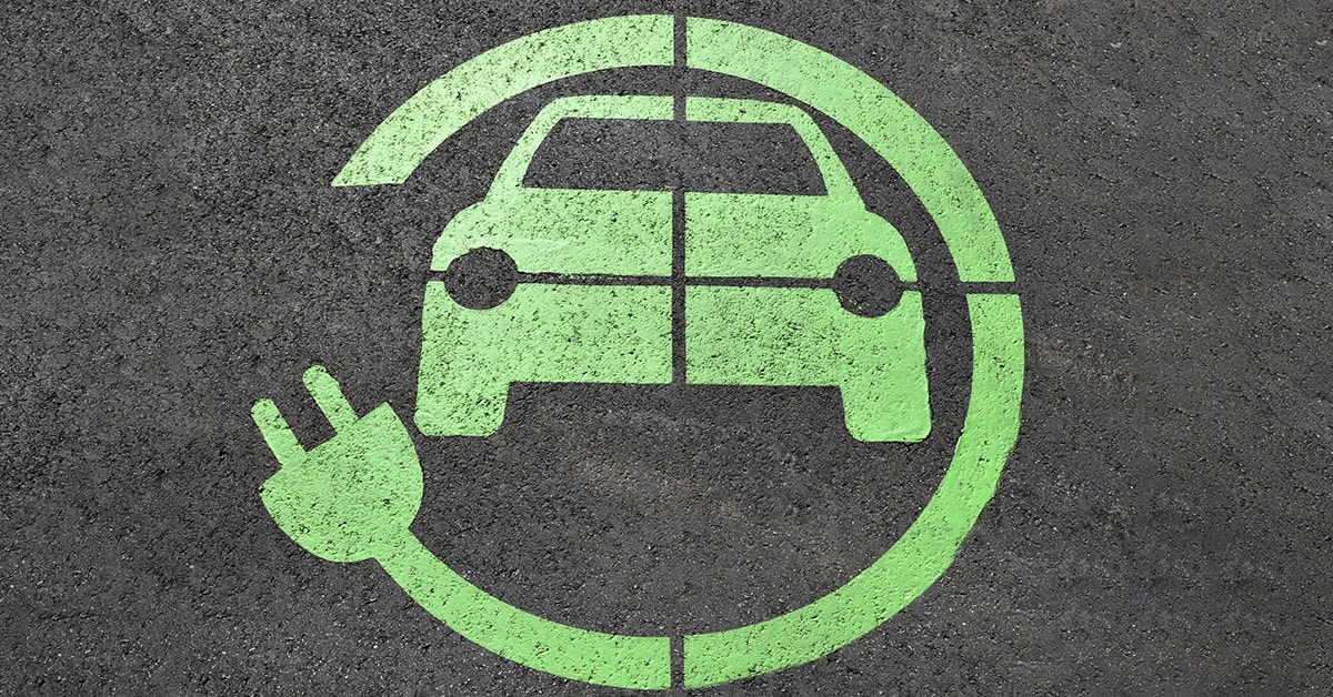 EV capable stall, with green EV logo around an image of an EV vehicle.