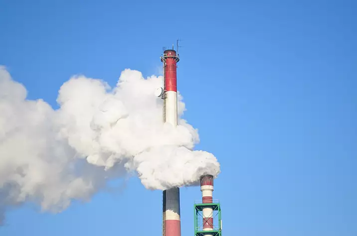 image of steam leaving a chimney in an industrial application