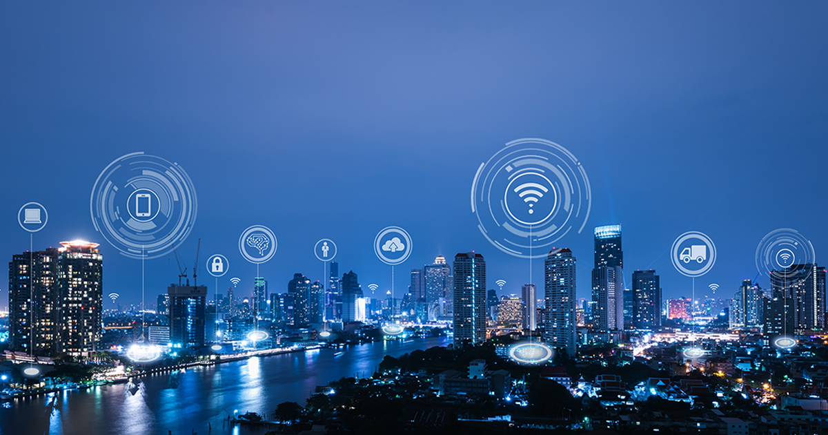 An image of a city with icons showing wifi connectivity, which is meant to represent building intelligence